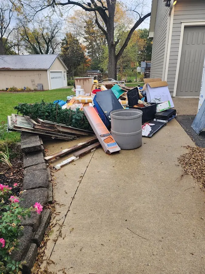 Dumpster being loaded with debris for Roofing Dumpster Rental in Irving